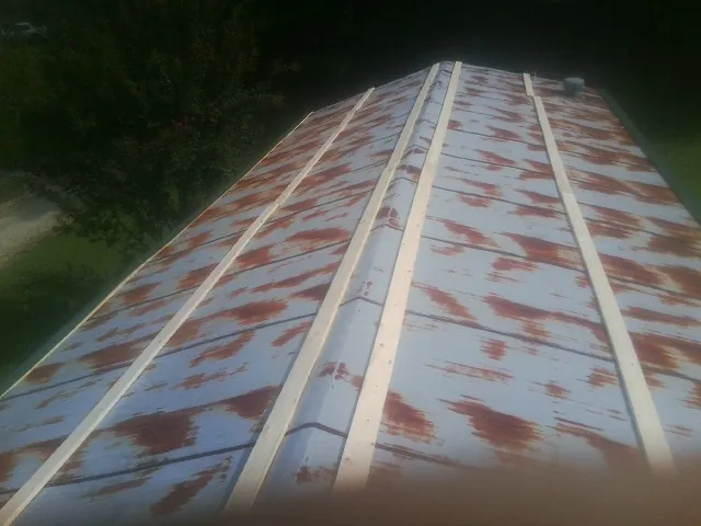Rusted metal roof panels with new wood purlins before replacement — Storm Damage Roof Repair in Donalsonville by Roofing Brothers